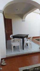 a black table and two chairs on a patio at casa Antony in San Teodoro