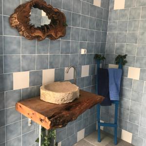 a bathroom with a sink and a mirror on the wall at Turismo Rural casa da céu in Amiães de Cima +70 photos