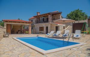 a swimming pool in front of a house at Luxury Villa Maria with Pool in Galovac