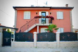 a house with a balcony with flowers on it at B&B LA PALMA in Ravarino