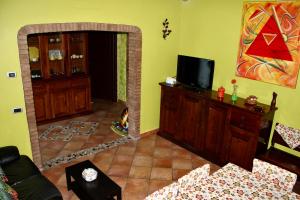a living room with a couch and a tv and a mirror at B&B LA PALMA in Ravarino