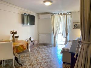 a living room with a table and a bed and a bedroom at “Ivory house”with sea view in Manarola