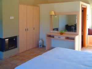 a room with a bedroom with a desk and a mirror at Enalia Gi in Límni +13 photos