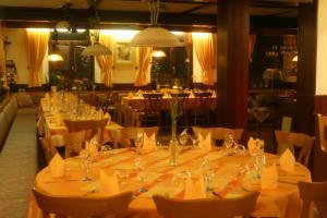 a long dining room with tables and chairs at Landgasthof Sonne in Bötzingen