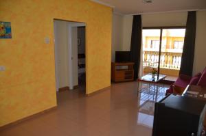 a living room with yellow walls and a room with a balcony at Hotel Playa Sol by ALEGRIA in Puerto de Mazarrón +19 photos