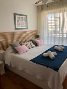 a bedroom with a large bed with two towels on it at Face à La Mer in Calafell
