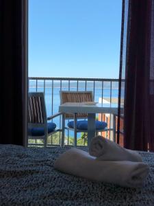 a person laying on a bed with a view of the ocean at Guest House Stipe in Brela