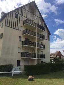 a building with balconies on the side of it at Face à la mer à Cabourg in Cabourg
