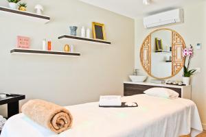 a room with a bed and a mirror at Hôtel La Villa Port d'Antibes & Spa in Antibes