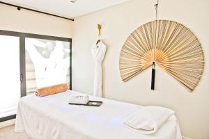 a bedroom with a white bed and a large mirror at Hôtel La Villa Port d'Antibes & Spa in Antibes