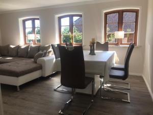a living room with a table and a couch at Ferienwohnung Familie Manthei in Boitin Resdorf