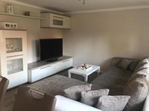 a living room with a couch and a flat screen tv at Ferienwohnung Familie Manthei in Boitin Resdorf