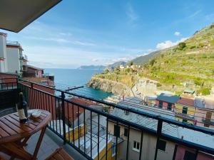 a balcony with a view of the ocean and buildings at “Ivory house”with sea view in Manarola