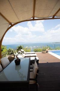 a patio with a table and chairs and a pool at NIAN villa sea in Drosia