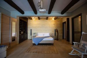 a bedroom with a bed and a wooden wall at NIAN villa sea in Drosia +81 photos