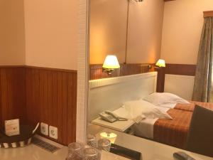 Postel nebo postele na pokoji v ubytování Hotel Olympic