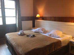 Postel nebo postele na pokoji v ubytování Hotel Olympic