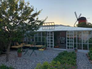 a conservatory with a windmill on top of it at Havings skafferi in Lysekil
