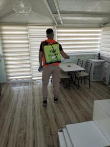 a man with a green backpack standing at a table at Melodi Club Apart in Davutlar +80 photos