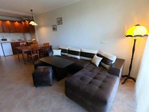 a living room with a couch and a table at Green Life Pool View Apartment in Sozopol