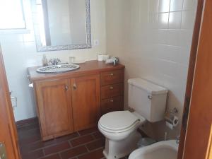 a bathroom with a white toilet and a sink at Casa Adega Do Mosteiro - Turismo Rural in Caldas da Rainha