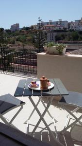 a table with a plate of food on a balcony at Mare e Relax in Castellammare del Golfo