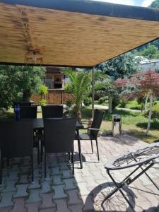 a patio with a table and chairs under an umbrella at Vacation Home Nukri in Gonio
