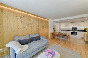 a living room with a couch and a kitchen at Thedrus luxury apt, swimming pool, SPA & more in Chamonix-Mont-Blanc