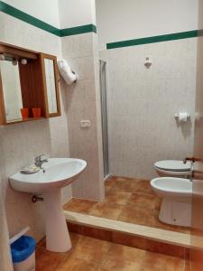 a bathroom with two sinks and a toilet at Residence Ristorante Baobab in Controguerra +21 photos