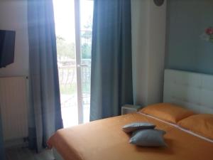 a bedroom with a bed with two pillows on it at Ana Rooms in Krk