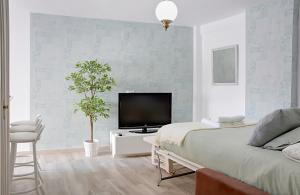 Televízia a/alebo spoločenská miestnosť v ubytovaní Apartamento Murillo