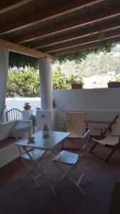 een patio met 2 stoelen en een tafel en stoelen bij Casa Michelina in Lipari