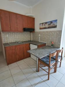 a kitchen with a table and a table and chairs at Ionion Studios in Kanali
