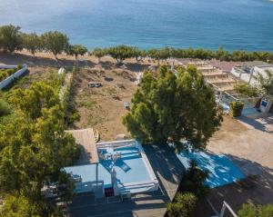 an aerial view of a beach with a swimming pool at Alexandros by the Beach - Serifos in Livadakia