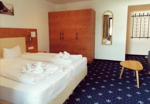 Posteľ alebo postele v izbe v ubytovaní Hotel Tirolerhof