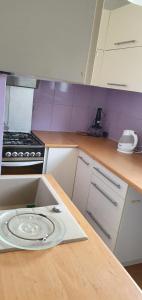 a kitchen with a wooden counter top with a plate on it at Mieszkanie nad morzem in Gdańsk