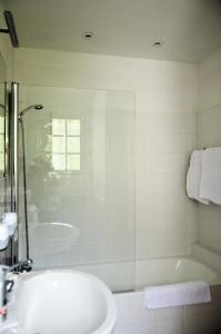 a bathroom with a tub and a sink and a shower at Les Orangers in Saint Paul de Vence