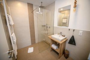 a bathroom with a sink and a shower at Landgasthaus & Hotel zur Krone in Dahn