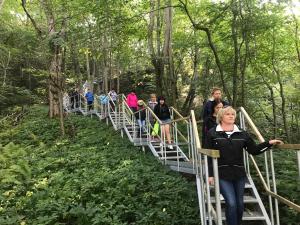 un grupo de personas caminando por un puente en el bosque en Valaste Puhkeküla, en Kohtla-Järve