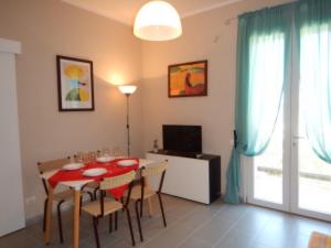 a dining room with a red table and chairs at Ville Paola e Daniela in San Vincenzo