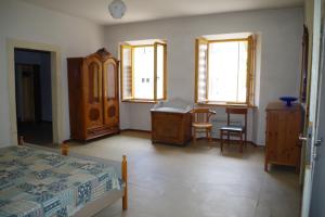 a bedroom with a bed and a desk and a chair at Da Francesca in Fiera di Primiero