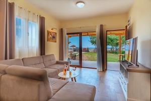 a living room with a couch and a table at Holiday Home Sea in Petrovac na Moru