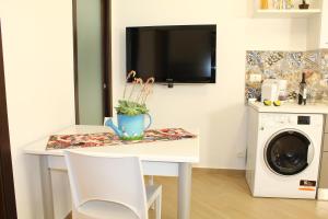 a laundry room with a table and a washing machine at Ciuri di Sicilia in Capaci