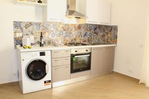 a kitchen with a washer and dryer in it at Ciuri di Sicilia in Capaci