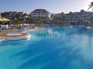 a large swimming pool in front of a resort at Parque Santiago 3 Luxery Apartment, Playa las Américas, Arona, Tenerife in Playa de las Americas