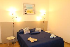 a bedroom with a blue bed and two lamps at Ciuri di Sicilia in Capaci