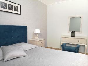 a bedroom with a bed and a blue chair at Pirofani Villa Apartments in Apolpaina +47 photos