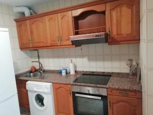 A cozinha ou kitchenette de Portonovo Suites by Serendipia Turismo