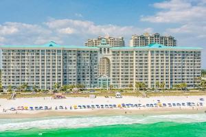 a view of a resort from the ocean with people on the beach at Majestic Sun in Destin