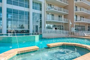 a large swimming pool in front of a building at Majestic Sun in Destin